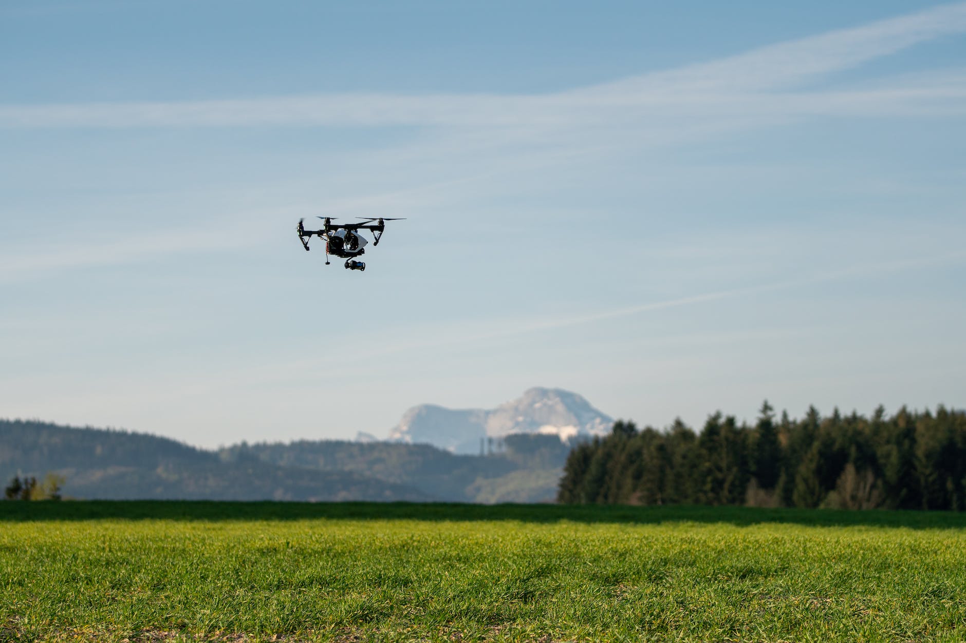 black drone on flight at the plains