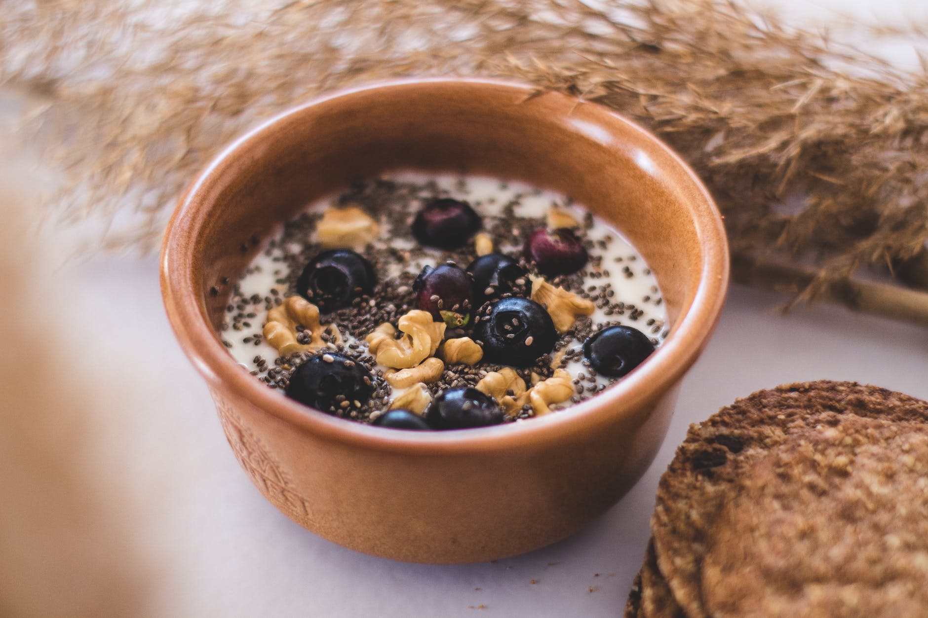 bowl of cereal with blueberries and walnuts