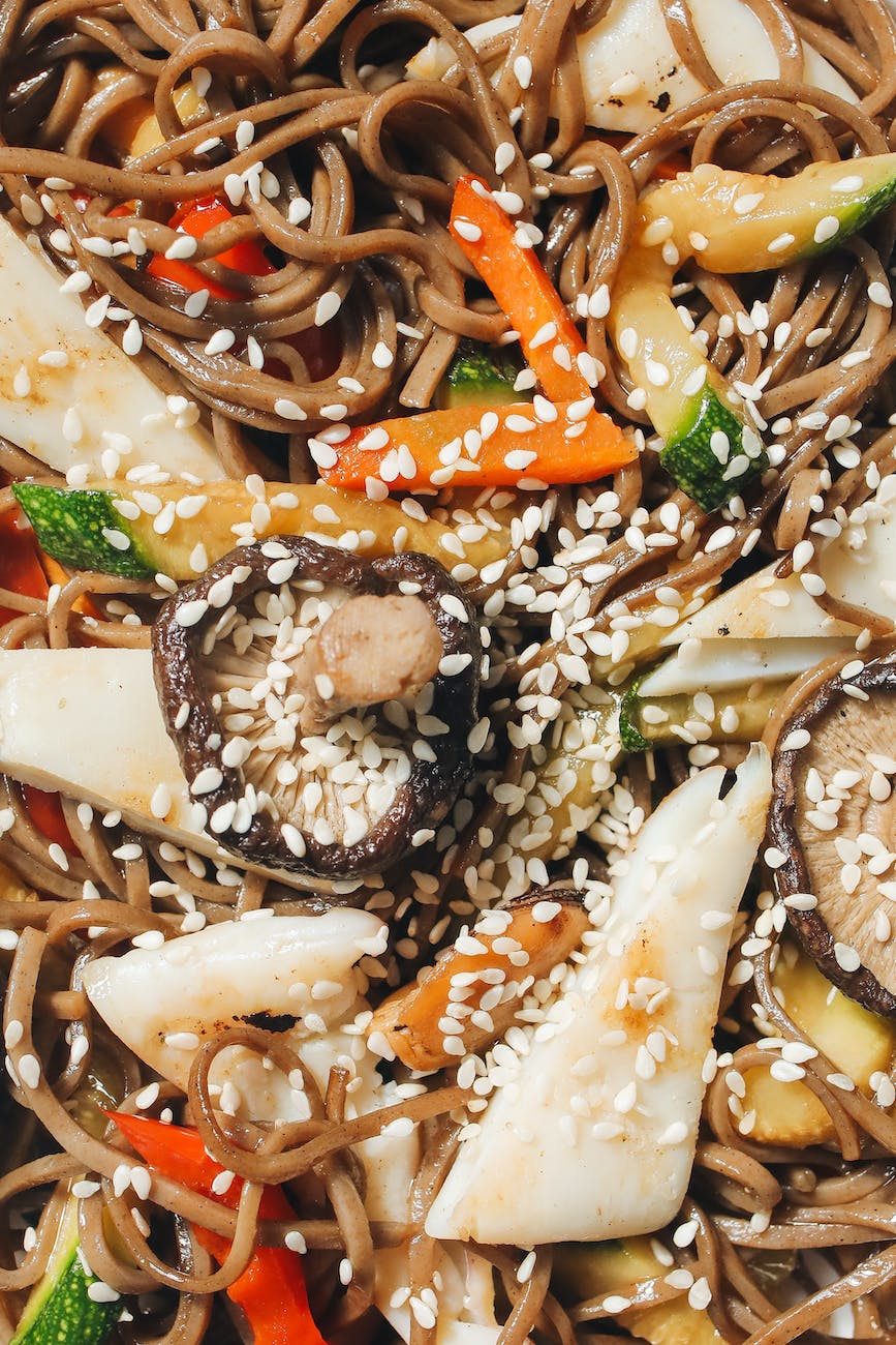 close up photo of noodle dish with sesame seeds