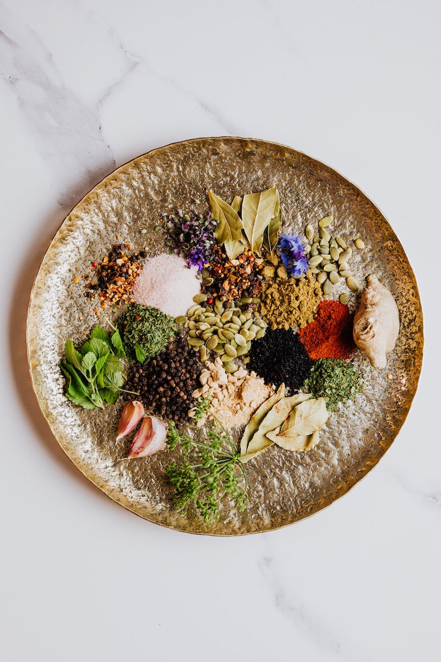 various spices and herbs on brown round plate