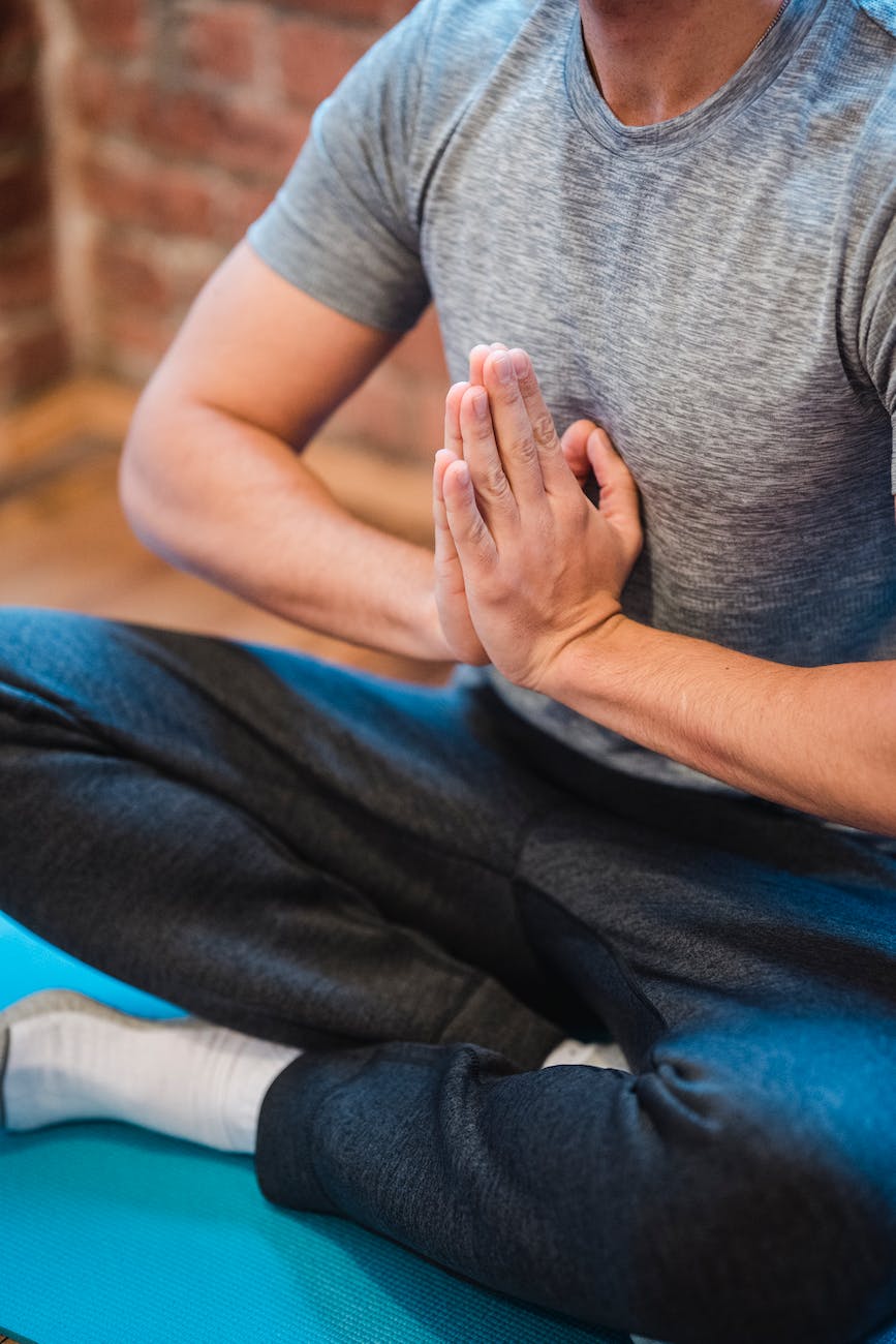 man meditating in easy sit posture with namaste posture