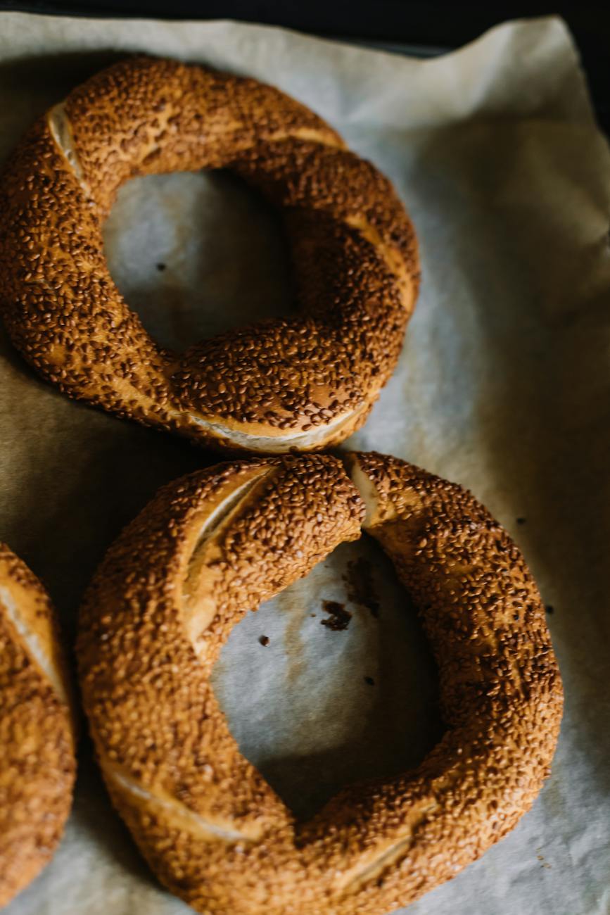 bagels with seeds on baking pan