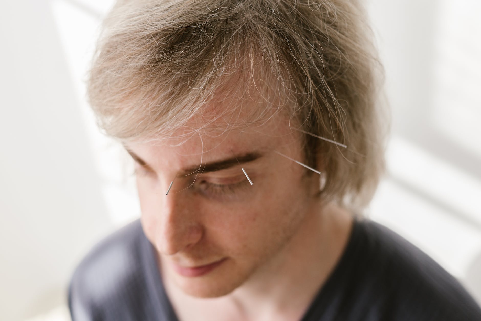 close up shot of a man with a needle on his face