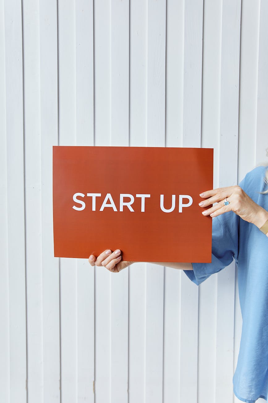 person holding a paper with start up sign