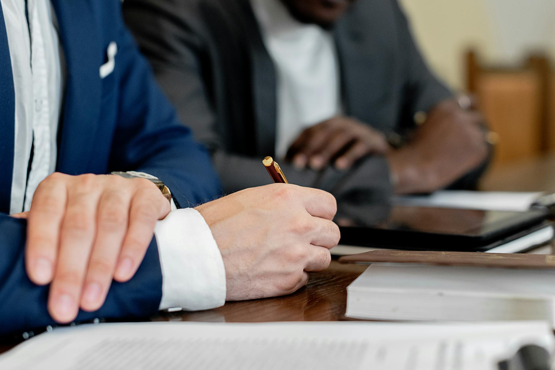 close up of businessmen sitting at the table with documents