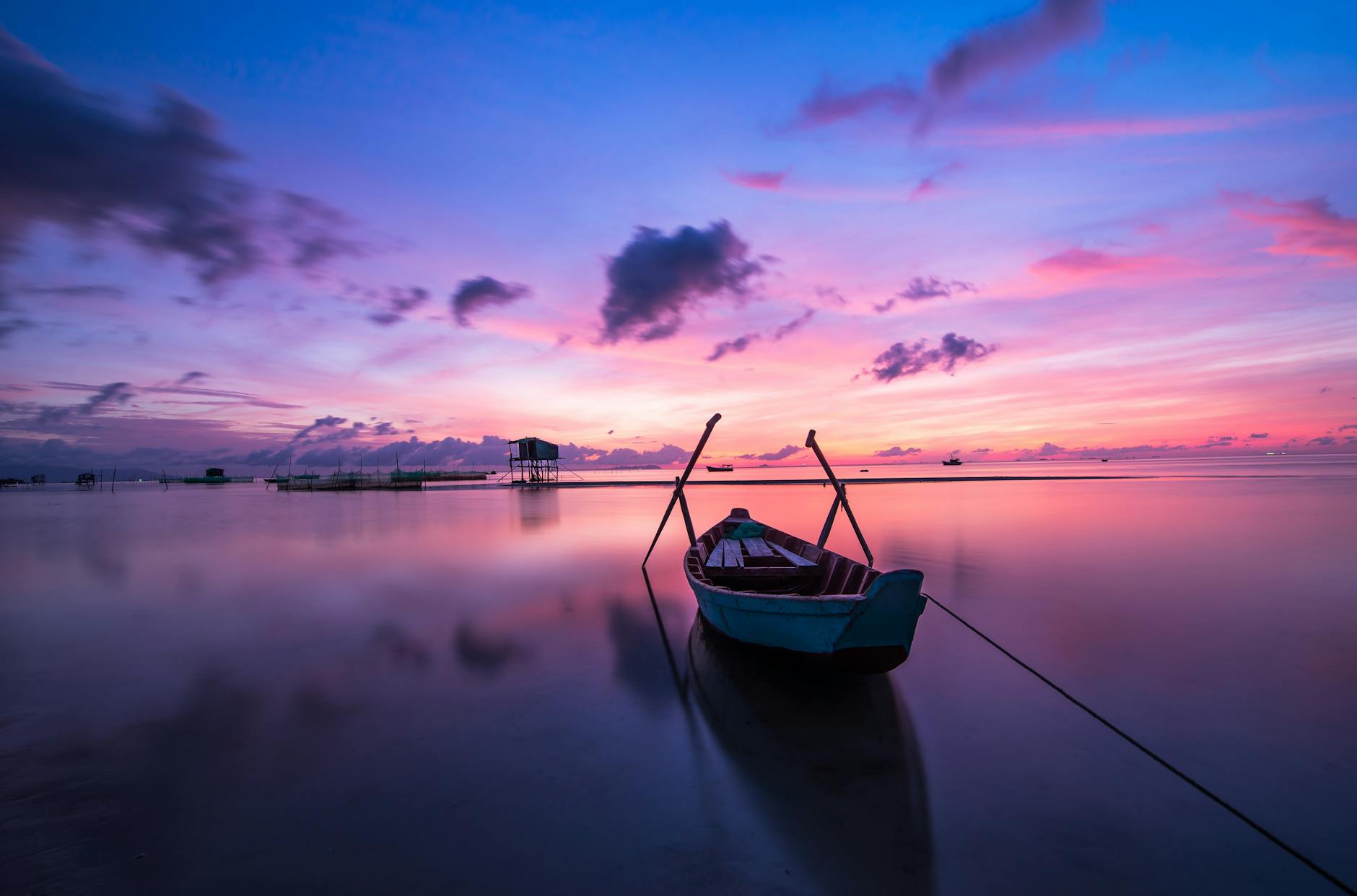 blue and white boat on body of water